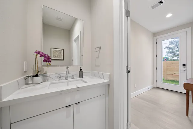 a en suite bathroom with a double vanity sink a mirror and a shower