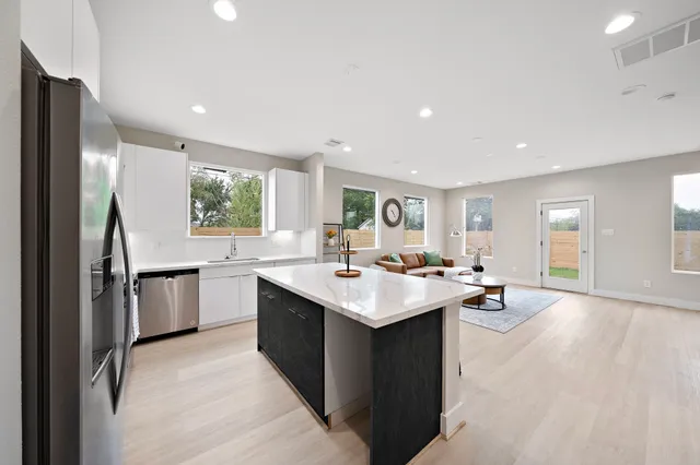 a kitchen with a sink stove and refrigerator