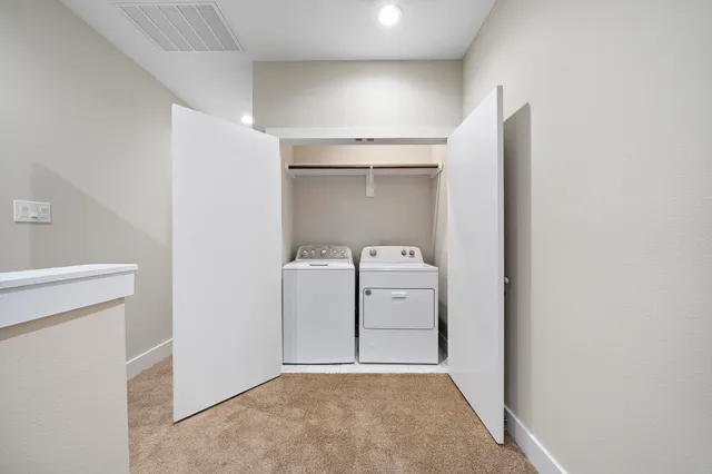 a view of a storage & utility room with a washer dryer
