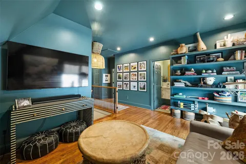 a living room with lots of furniture and a wooden floor
