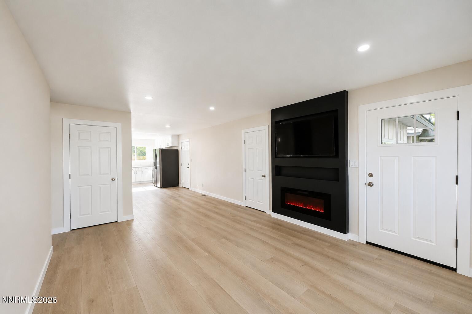 742 Ruth Street Carson City, NV 89701 - Photo 4 of 25 a view of an empty room with wooden floor fireplace and a window