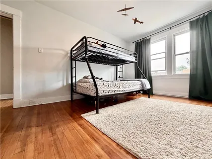 a bedroom with two beds and a window
