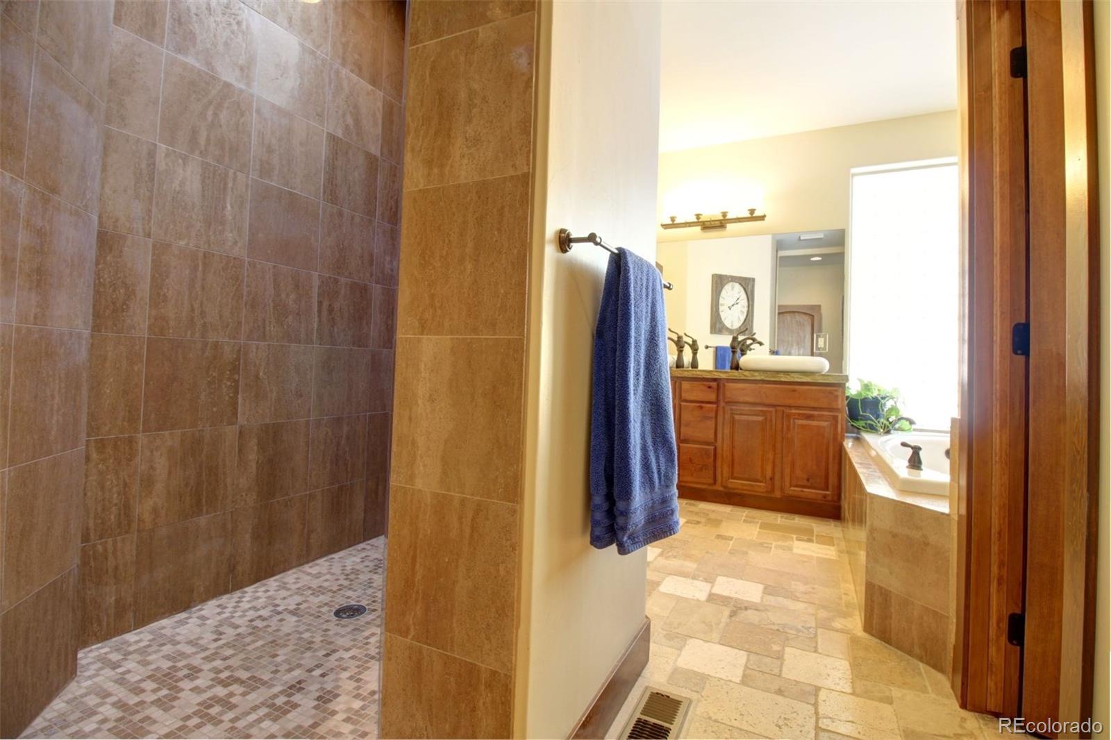 3095 South Piney Ridge Road Evergreen, CO 80439 - Photo 11 of 30 a bathroom with a shower