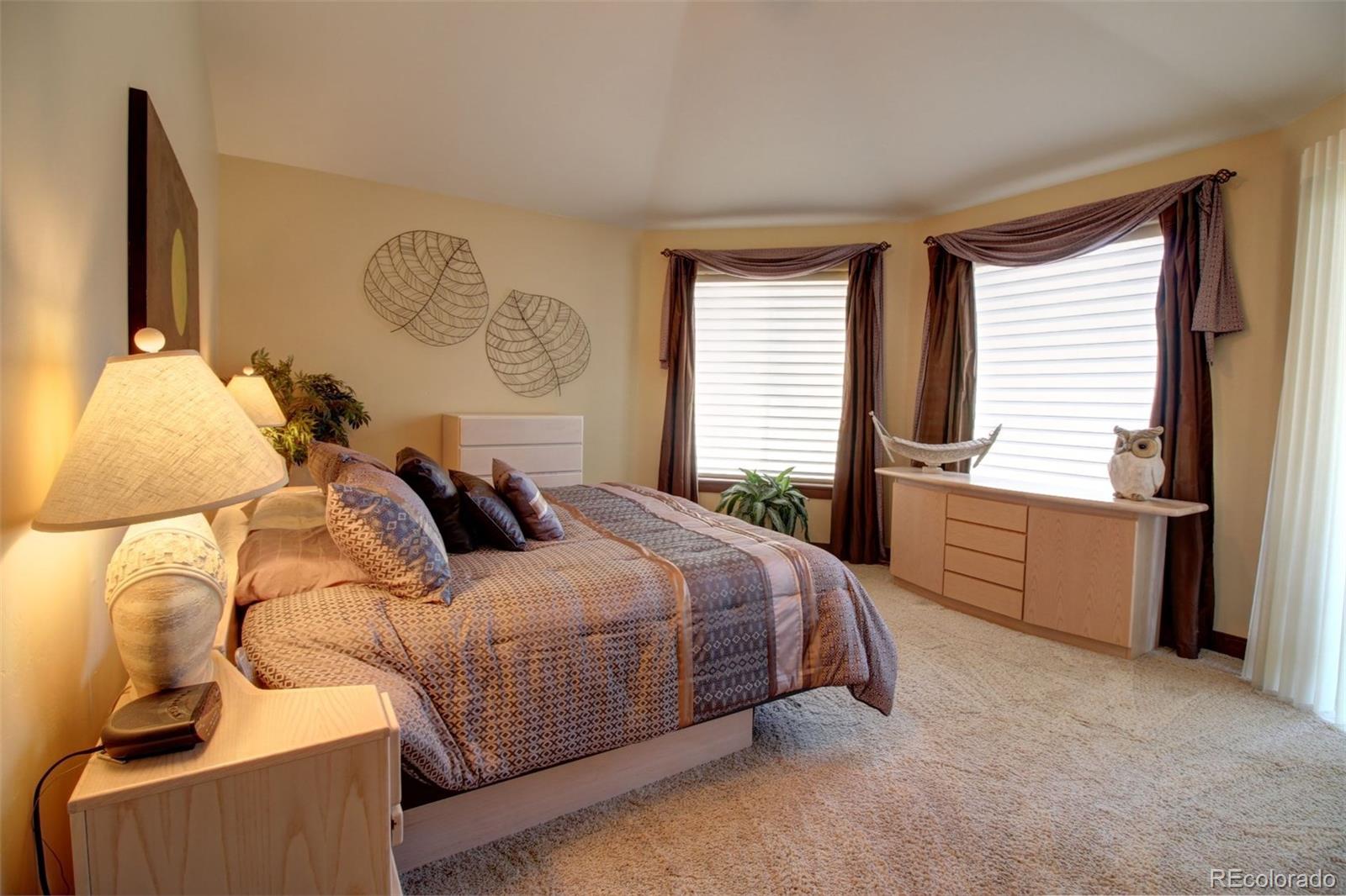 3095 South Piney Ridge Road Evergreen, CO 80439 - Photo 13 of 30 a bedroom with a bed and a cabinets
