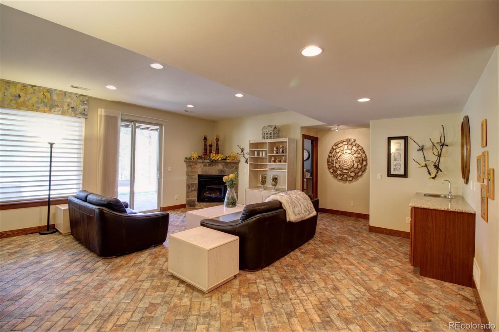 3095 South Piney Ridge Road Evergreen, CO 80439 - Photo 18 of 30 a living room with furniture and a flat screen tv