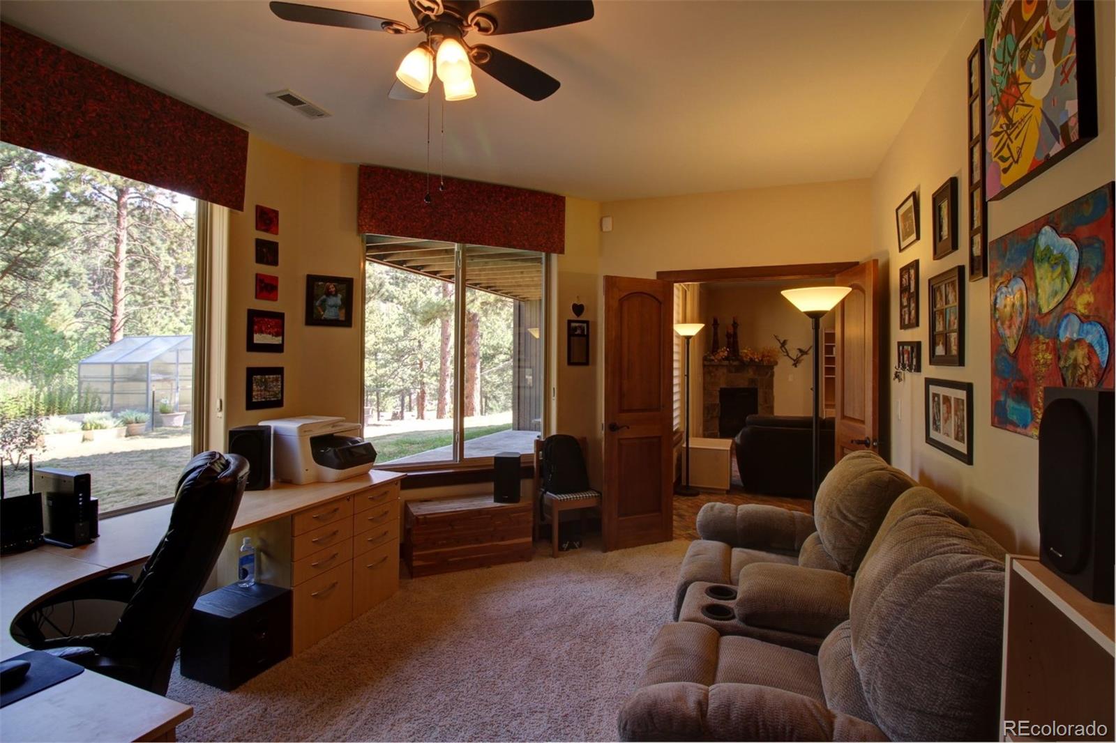 3095 South Piney Ridge Road Evergreen, CO 80439 - Photo 19 of 30 a living room with furniture and a large window
