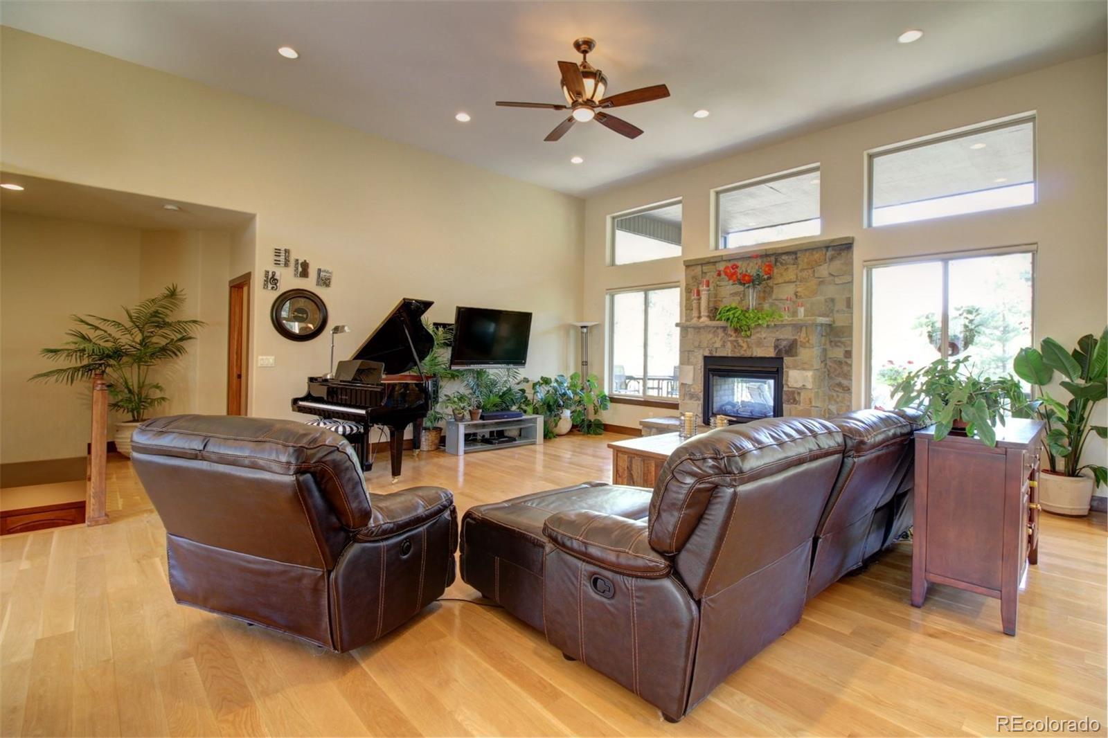 3095 South Piney Ridge Road Evergreen, CO 80439 - Photo 2 of 30 a living room with furniture fireplace and window