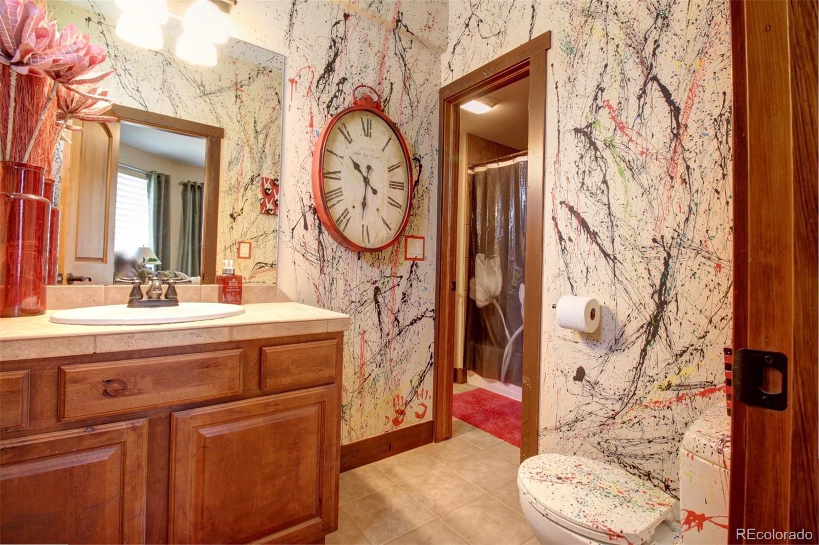 3095 South Piney Ridge Road Evergreen, CO 80439 - Photo 21 of 30 a bathroom with a toilet and a sink