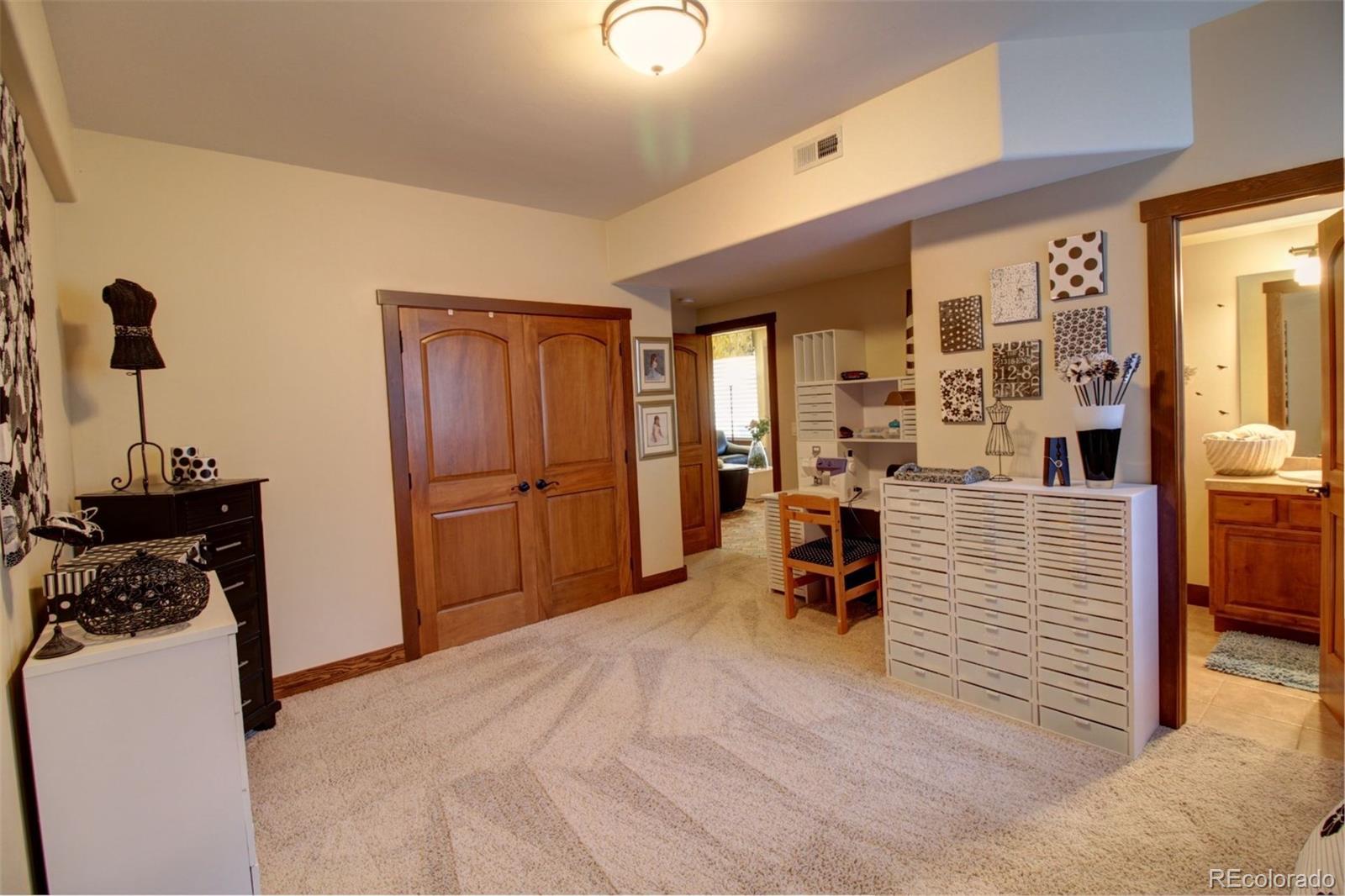 3095 South Piney Ridge Road Evergreen, CO 80439 - Photo 23 of 30 a view of a hallway with workspace and a window