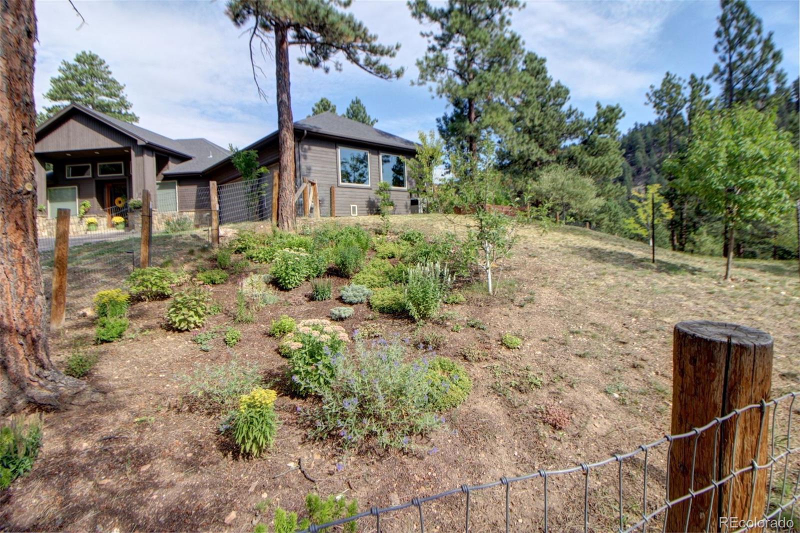 3095 South Piney Ridge Road Evergreen, CO 80439 - Photo 25 of 30 a front view of a house with a yard