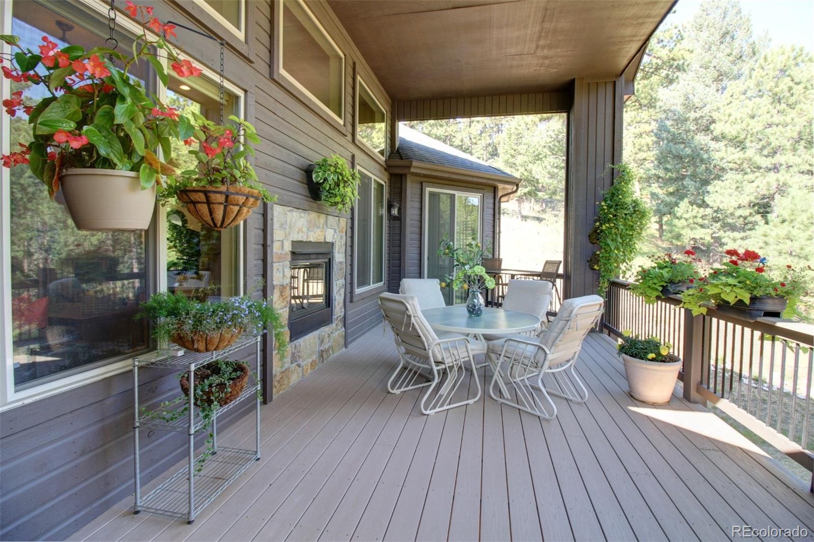 3095 South Piney Ridge Road Evergreen, CO 80439 - Photo 28 of 30 a view of a house with patio and a yard