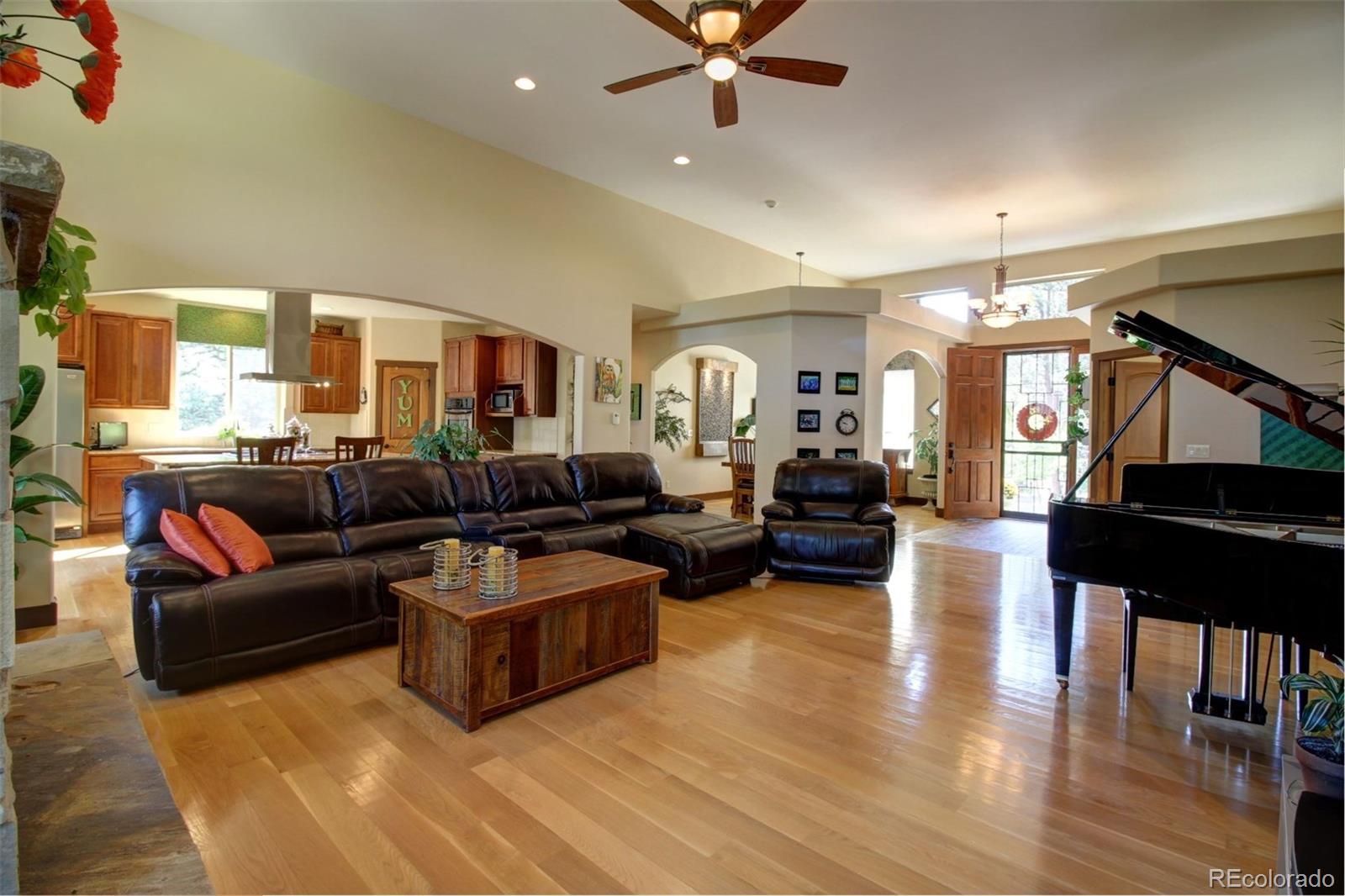 3095 South Piney Ridge Road Evergreen, CO 80439 - Photo 3 of 30 a living room with furniture and a wooden floor