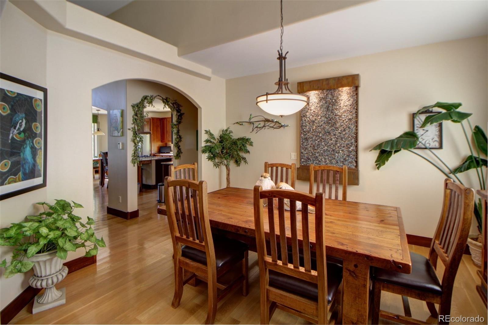 3095 South Piney Ridge Road Evergreen, CO 80439 - Photo 4 of 30 a view of a dining room with furniture and wooden floor
