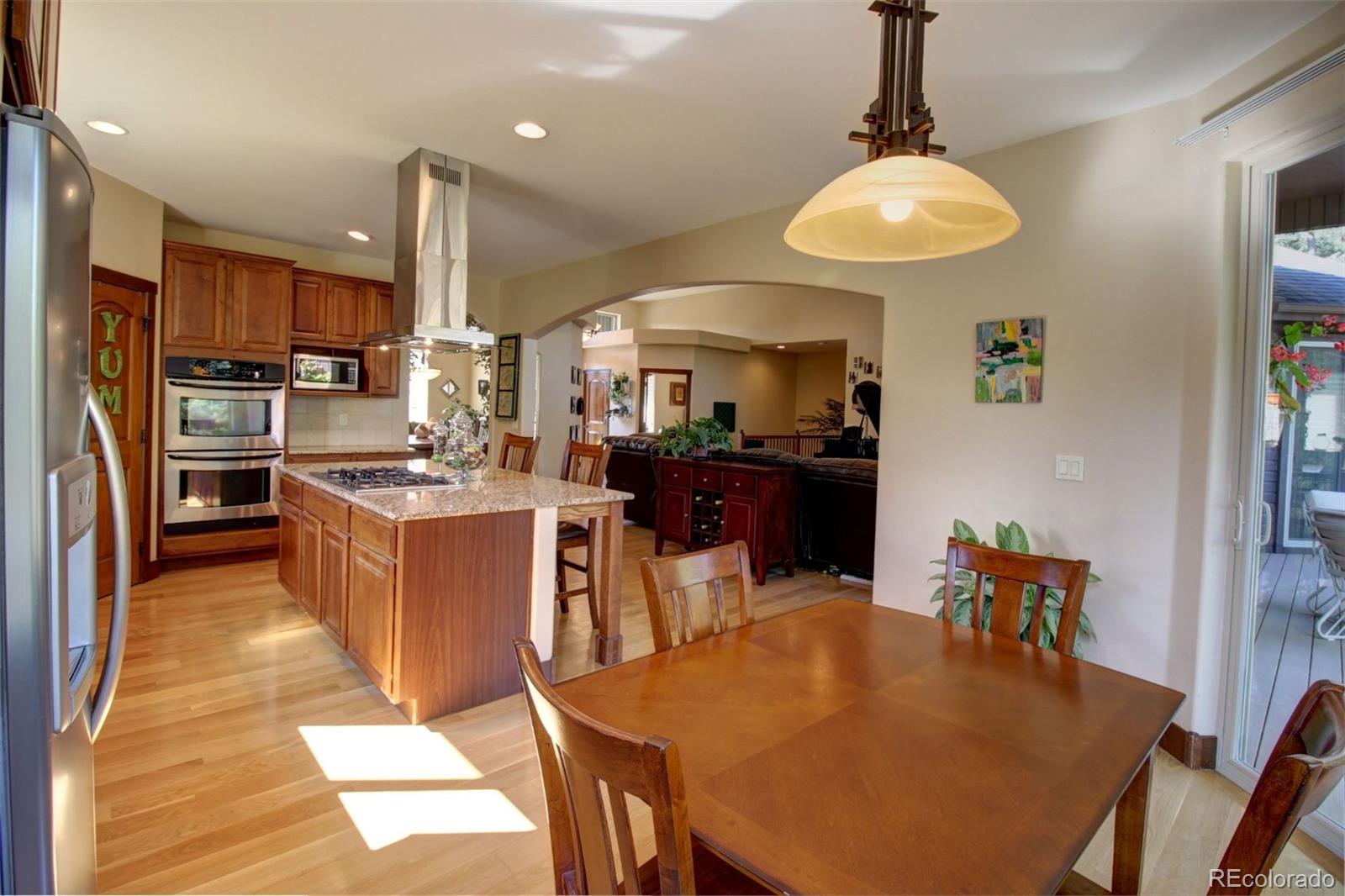 3095 South Piney Ridge Road Evergreen, CO 80439 - Photo 7 of 30 a large kitchen with a table and chairs