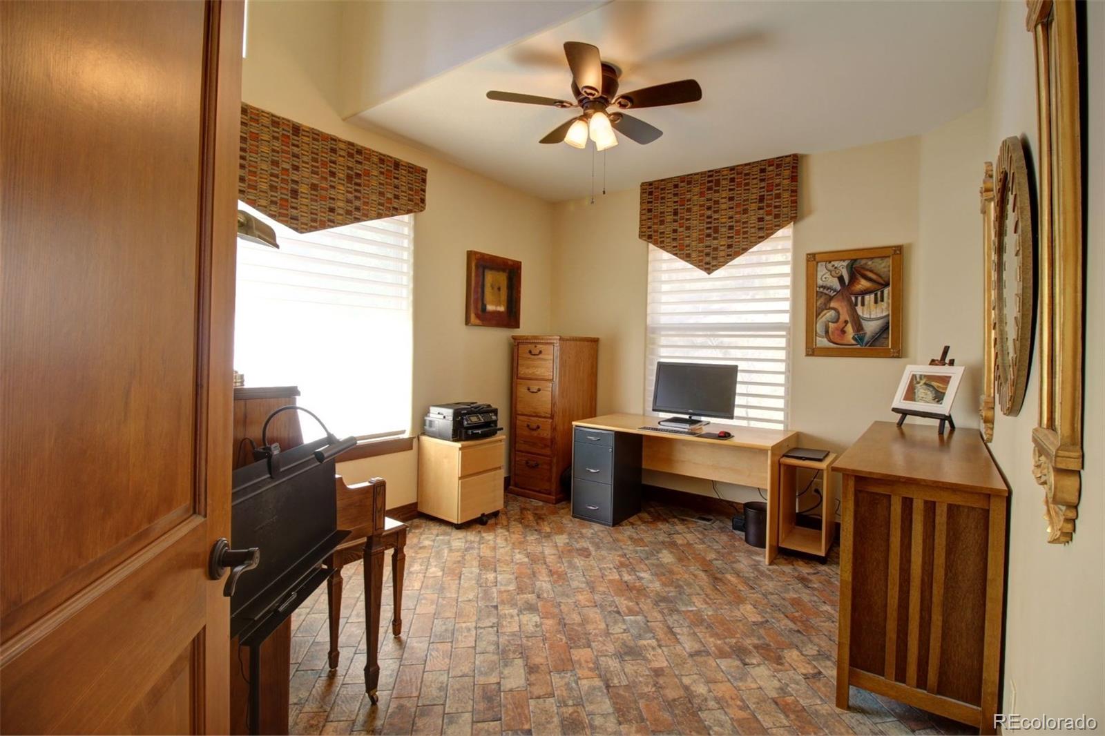 3095 South Piney Ridge Road Evergreen, CO 80439 - Photo 9 of 30 a living room with furniture windows and a flat screen tv