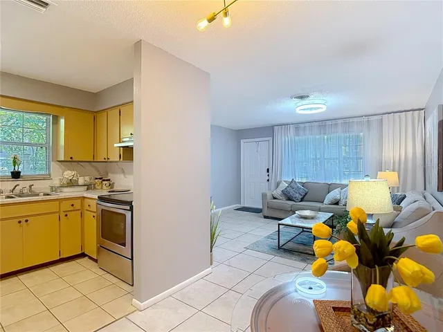 a kitchen with a refrigerator sink stove and cabinets