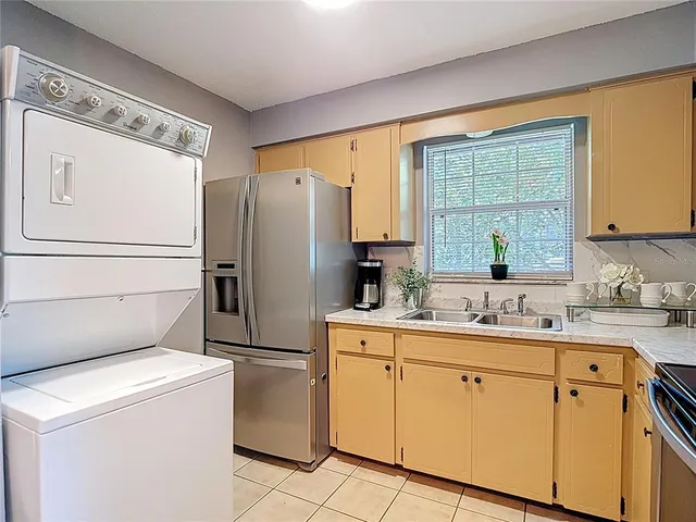 a kitchen with a sink stove and refrigerator