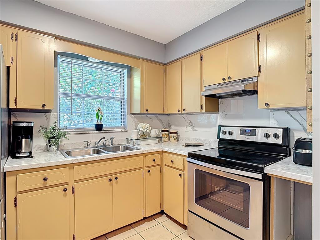137 Southeast Jefferson Circle North St. Petersburg, FL 33703 - Photo 16 of 24 a kitchen with a sink stove and cabinets