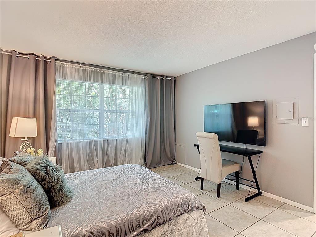 137 Southeast Jefferson Circle North St. Petersburg, FL 33703 - Photo 17 of 24 a bedroom with a bed and a window