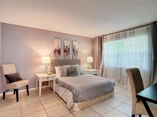 a bedroom with furniture and a window