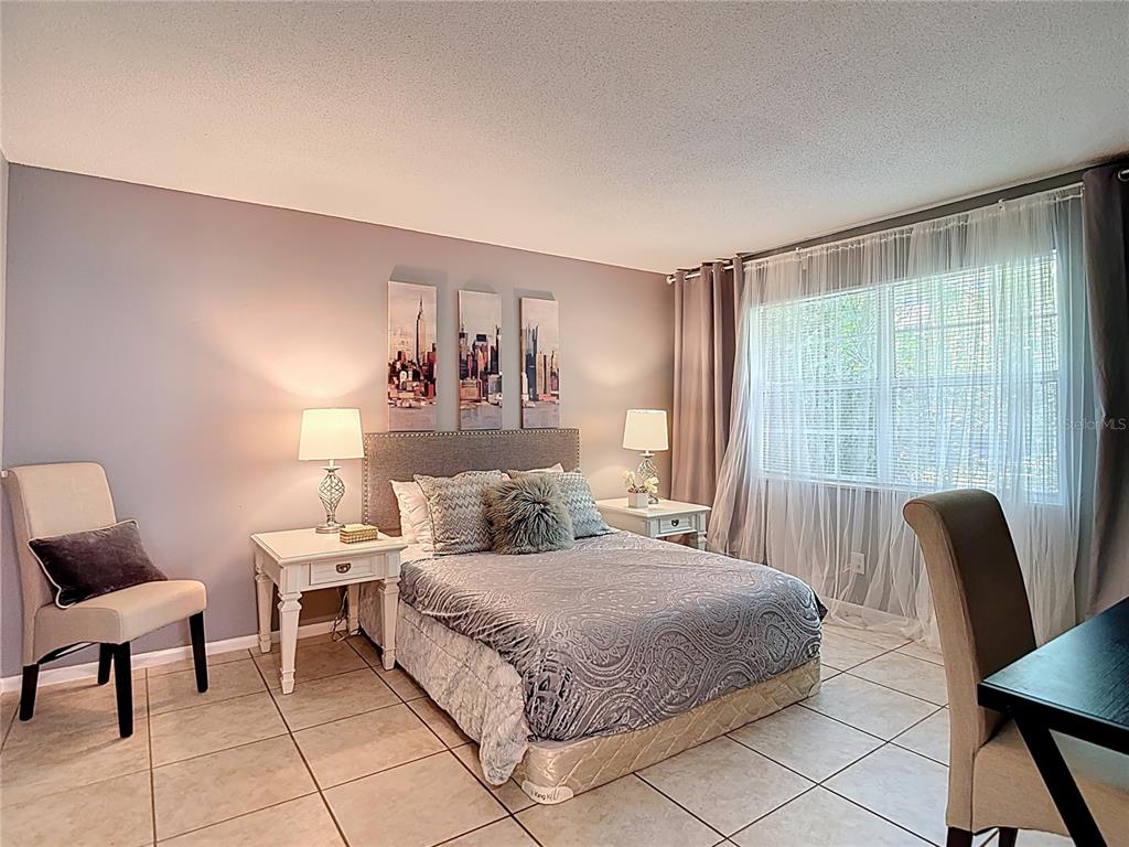 137 Southeast Jefferson Circle North St. Petersburg, FL 33703 - Photo 18 of 24 a bedroom with a bed and a chair