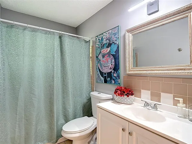 a bathroom with a toilet a sink and a shower
