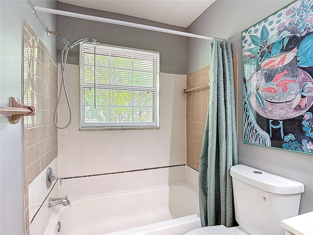 137 Southeast Jefferson Circle North St. Petersburg, FL 33703 - Photo 22 of 24 a bathroom with a toilet a sink and a shower