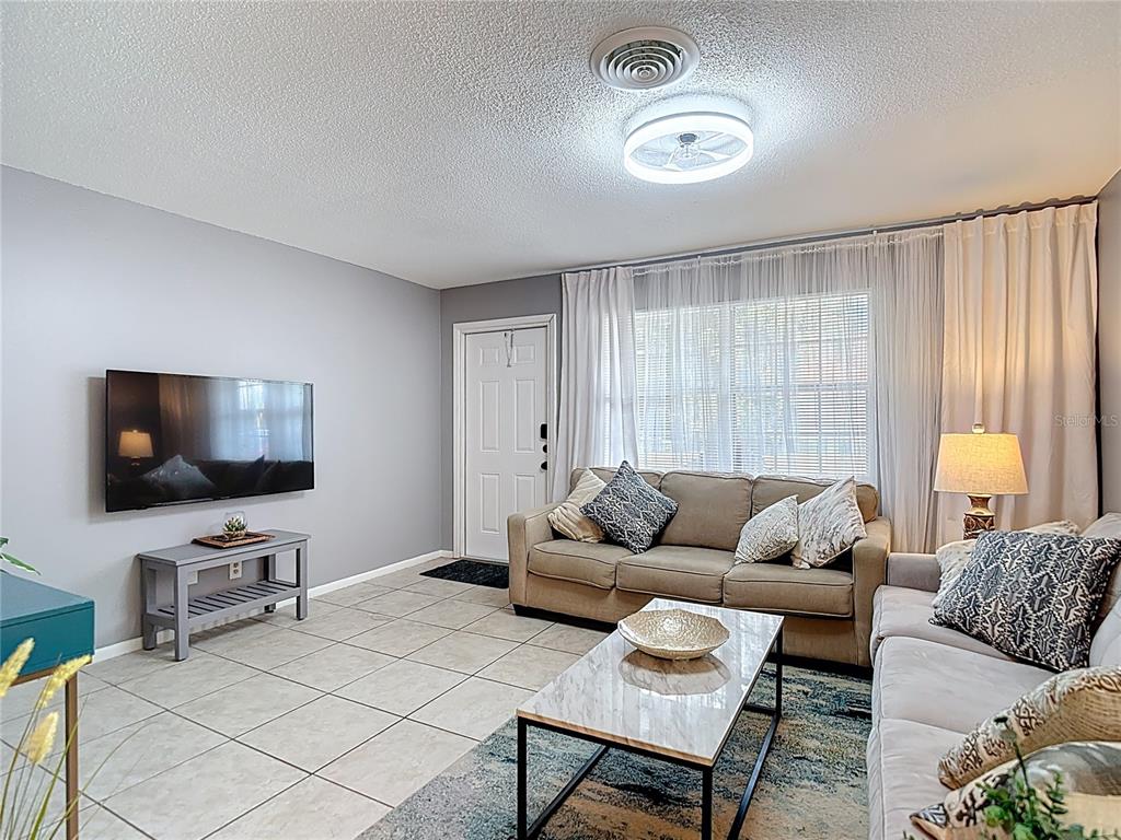 137 Southeast Jefferson Circle North St. Petersburg, FL 33703 - Photo 8 of 24 a living room with furniture and a flat screen tv