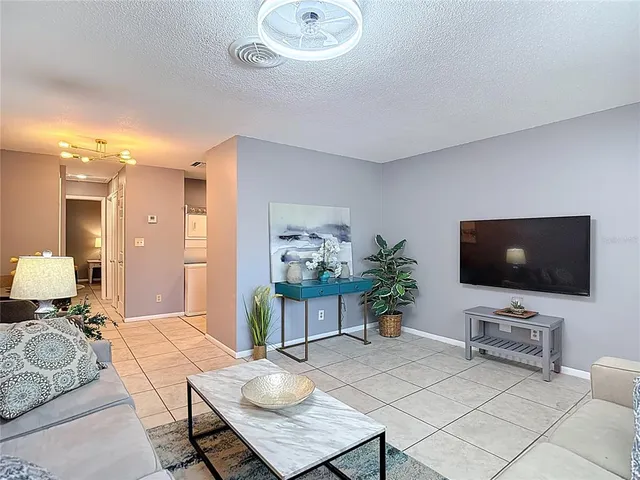 a living room with furniture and a dining table