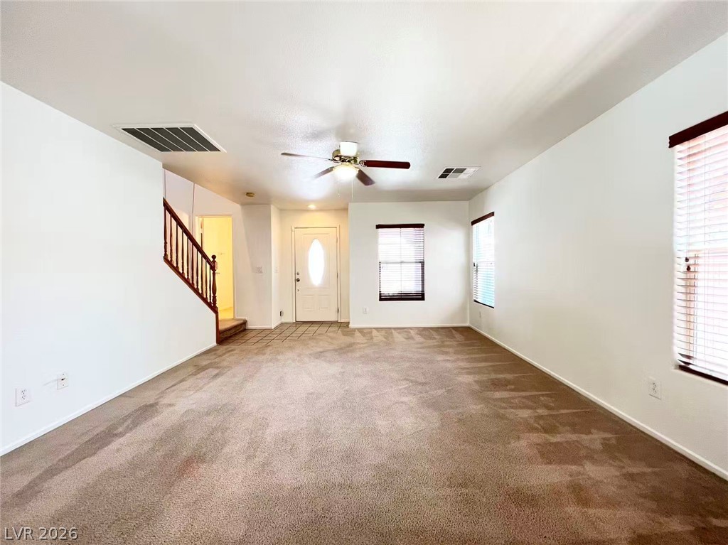 11143 Ranch Valley Street Las Vegas, NV 89179 - Photo 5 of 23 A versatile living space welcomes you with plush carpeting, offering comfort and style.