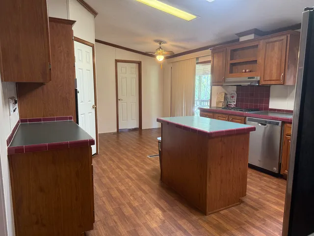 a room with wooden floors and wooden cabinets