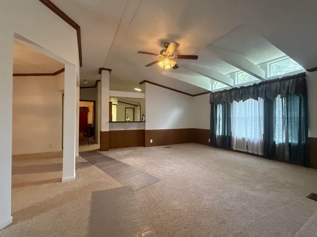 a view of empty room with ceiling fan