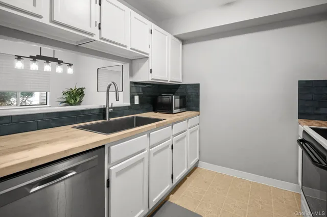 a kitchen with a sink and cabinets