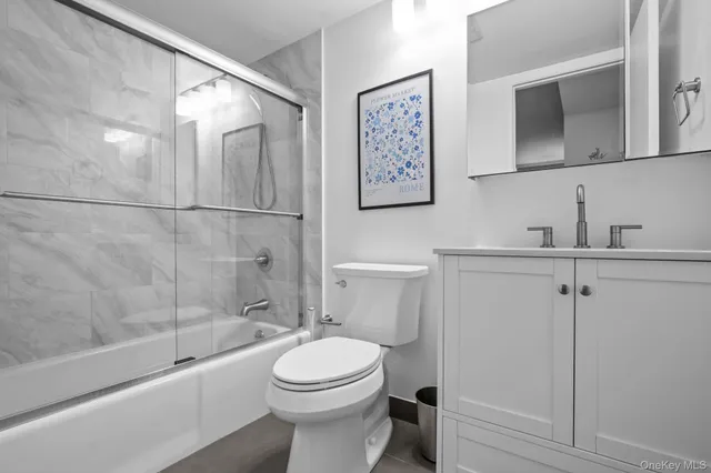 a bathroom with a toilet a sink and bathtub