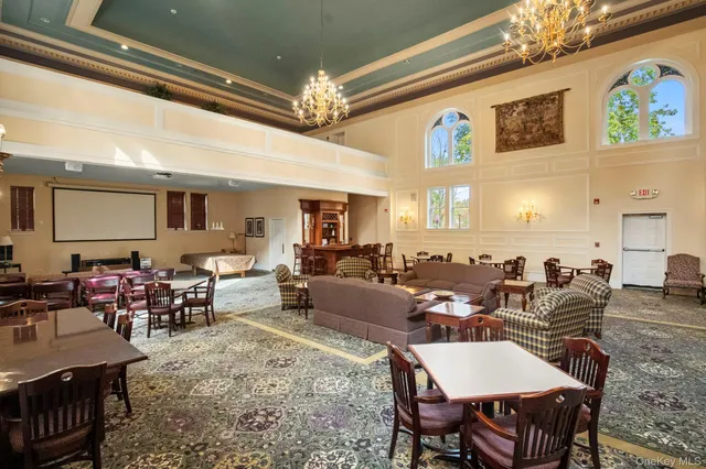 a living room with lots of furniture and a chandelier