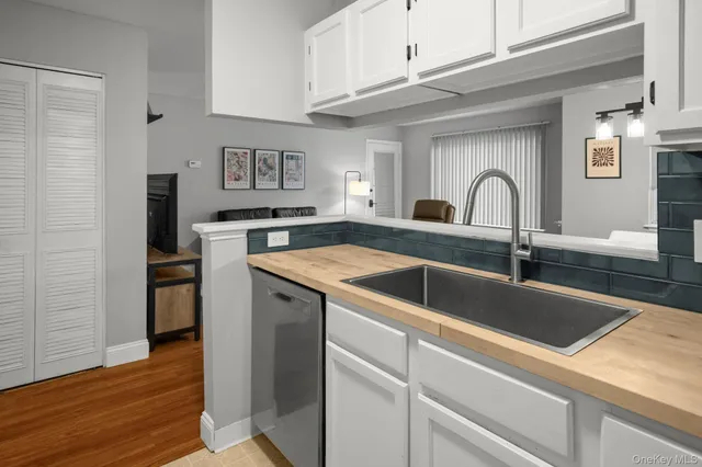 a view with granite countertop a sink and a refrigerator