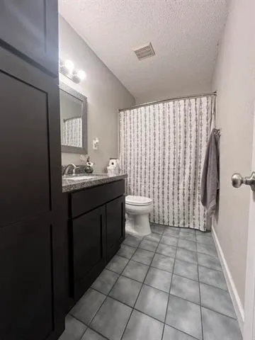 a bedroom with a bed and ceiling fan