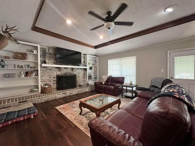a living room with furniture a flat screen tv and a fireplace