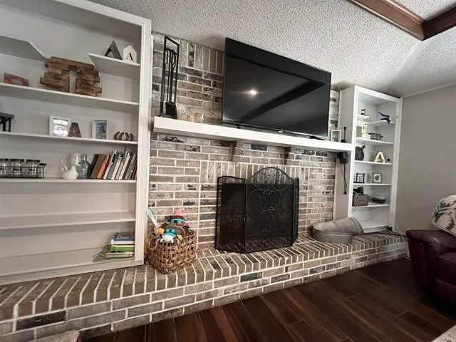 a living room with fireplace furniture and a flat screen tv