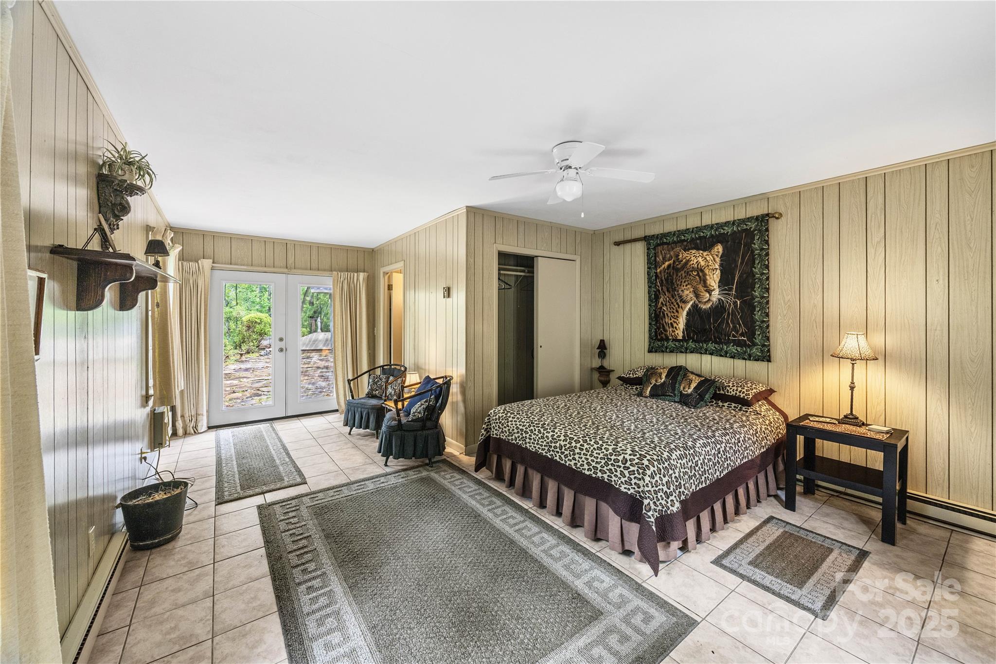 603 Green Hills Road Mill Spring, NC 28756 - Photo 15 of 47 a living room with a bed and a chandelier
