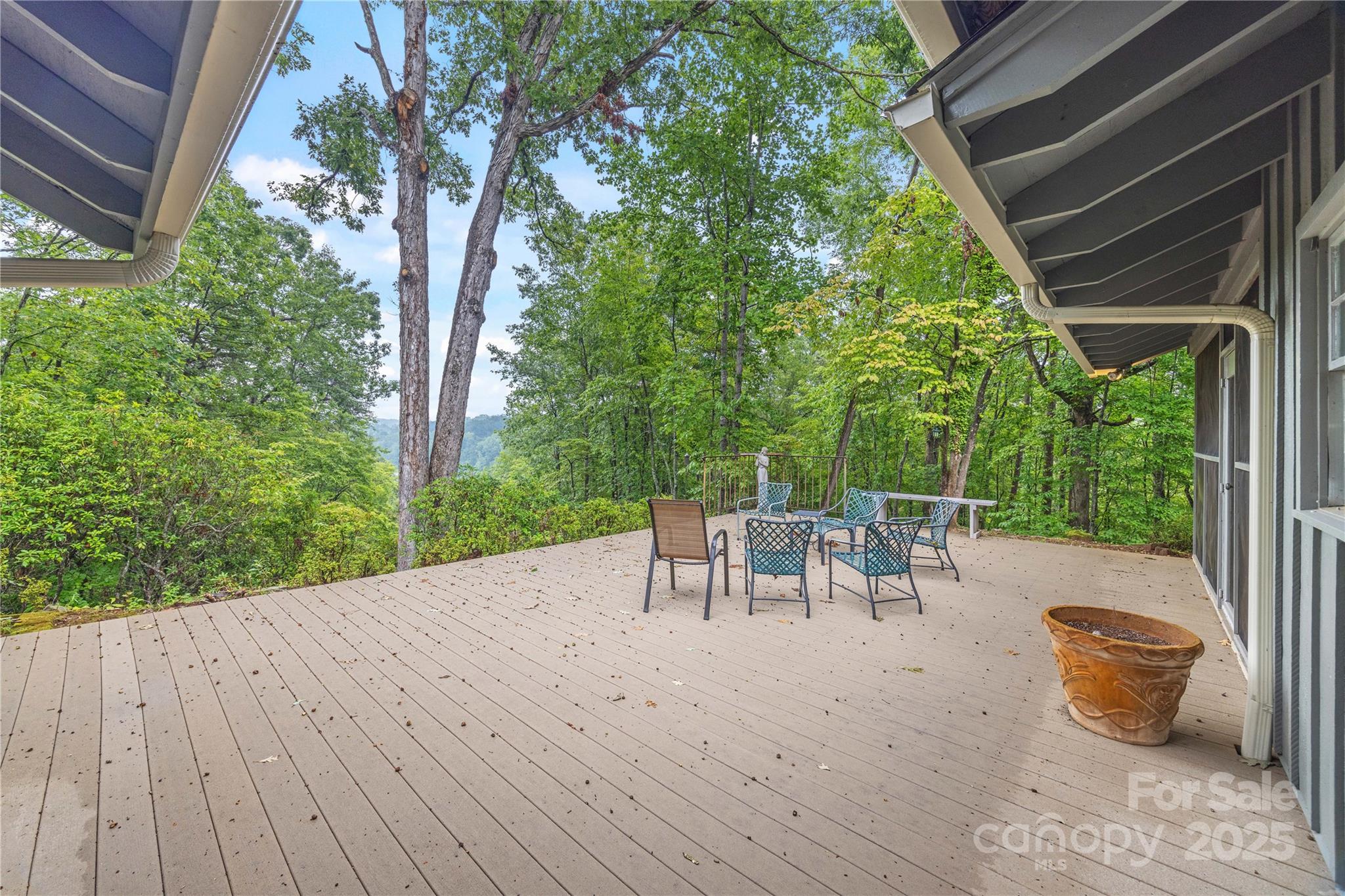 603 Green Hills Road Mill Spring, NC 28756 - Photo 22 of 47 a view of a patio with table and chairs and wooden floor