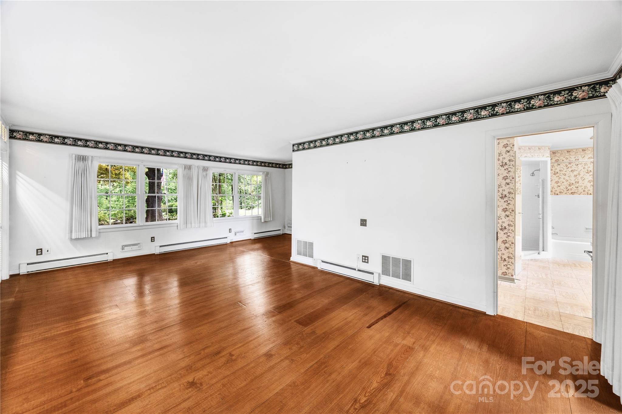 603 Green Hills Road Mill Spring, NC 28756 - Photo 28 of 47 a view of an empty room with wooden floor and a window