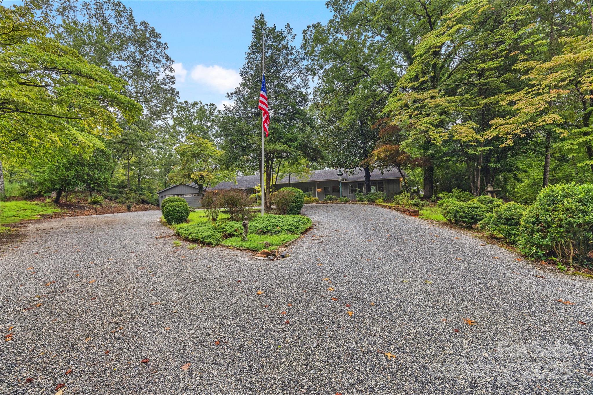603 Green Hills Road Mill Spring, NC 28756 - Photo 40 of 47 a front view of a house with a yard and potted plants