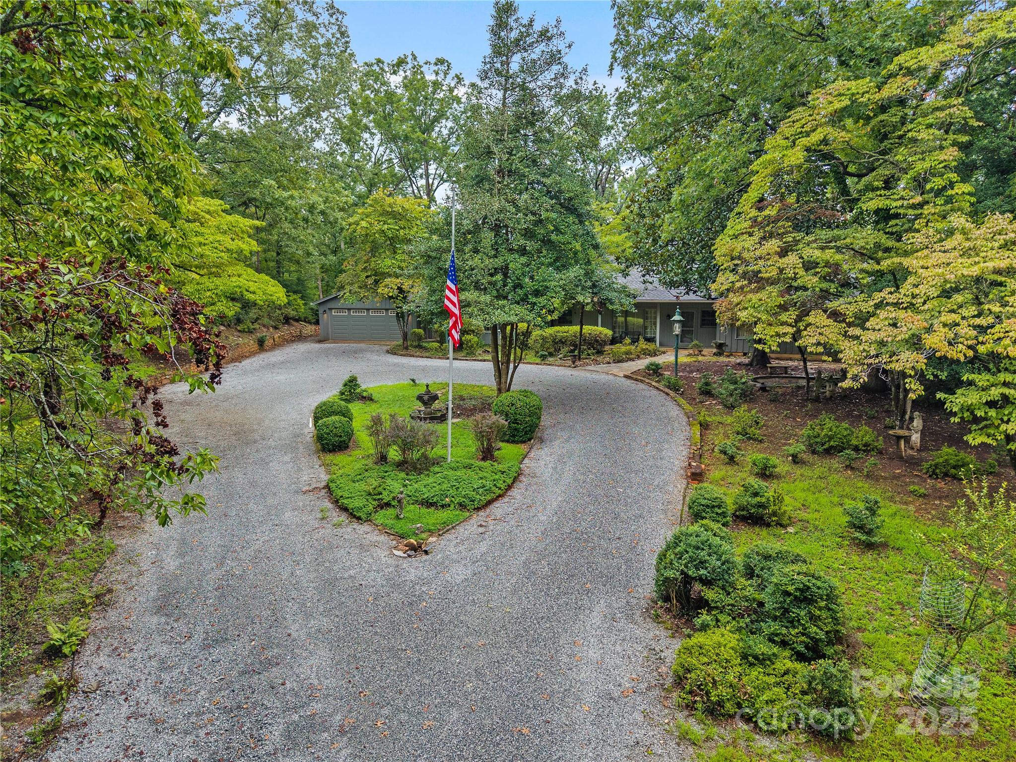 603 Green Hills Road Mill Spring, NC 28756 - Photo 43 of 47 a view of a garden with a patio