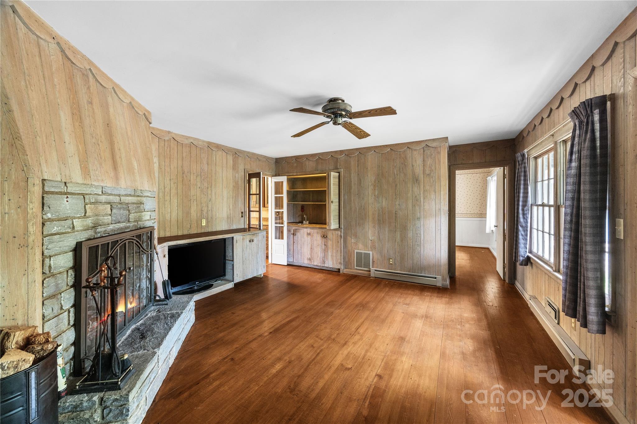 603 Green Hills Road Mill Spring, NC 28756 - Photo 5 of 47 a view of livingroom with hardwood floor and a ceiling fan