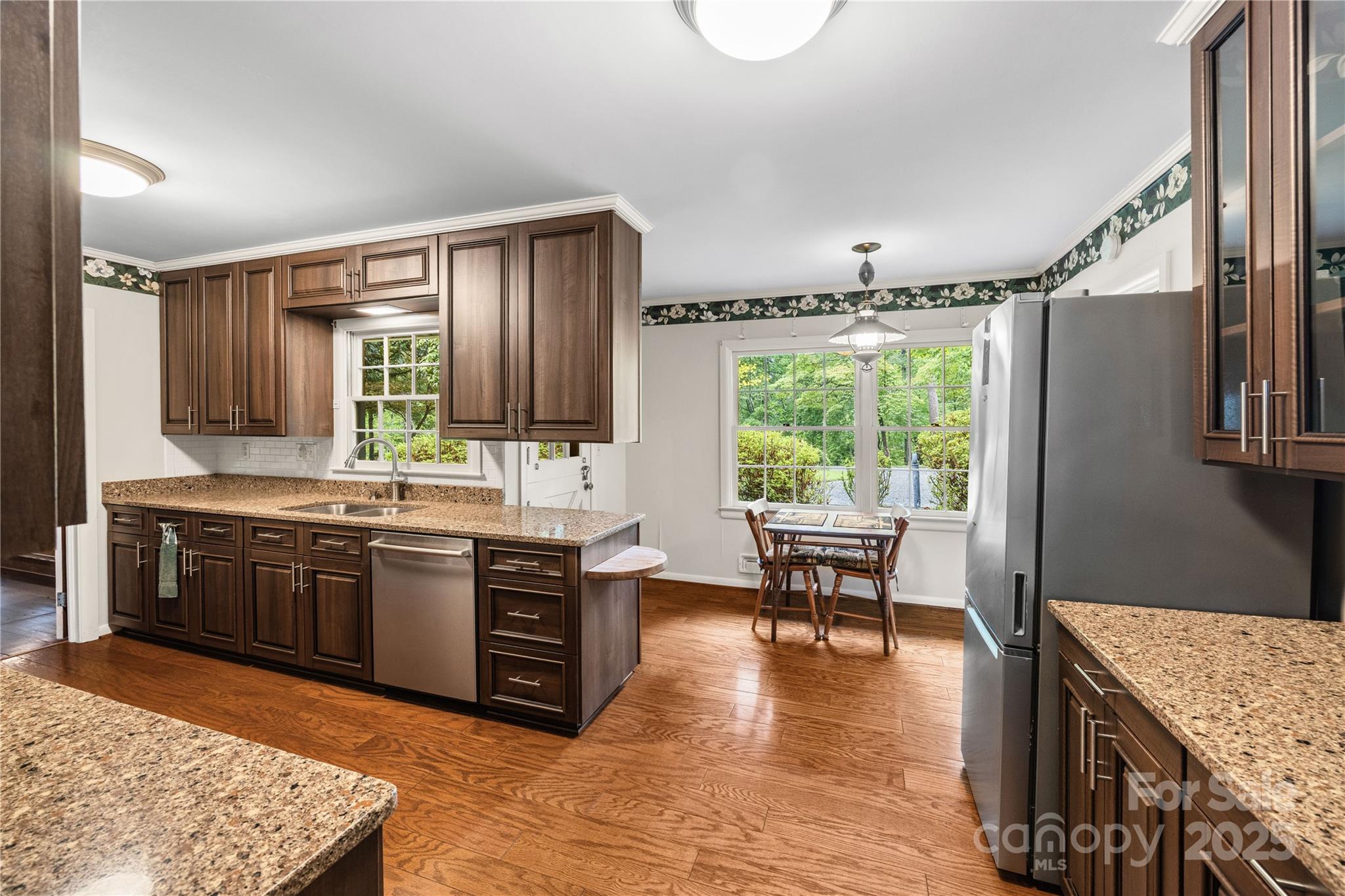 603 Green Hills Road Mill Spring, NC 28756 - Photo 6 of 47 a kitchen with stainless steel appliances granite countertop sink stove top oven and cabinets