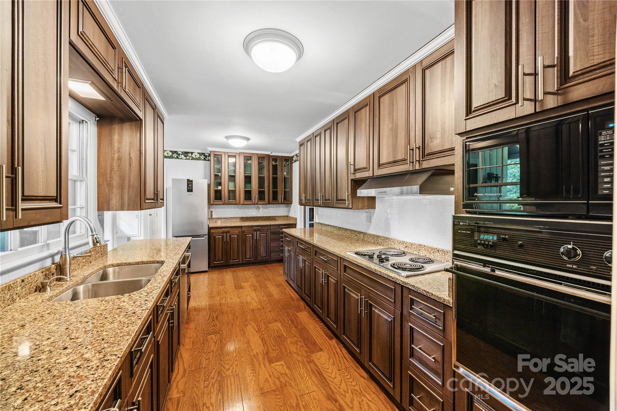 603 Green Hills Road Mill Spring, NC 28756 - Photo 7 of 47 a kitchen with kitchen island granite countertop a stove and a sink
