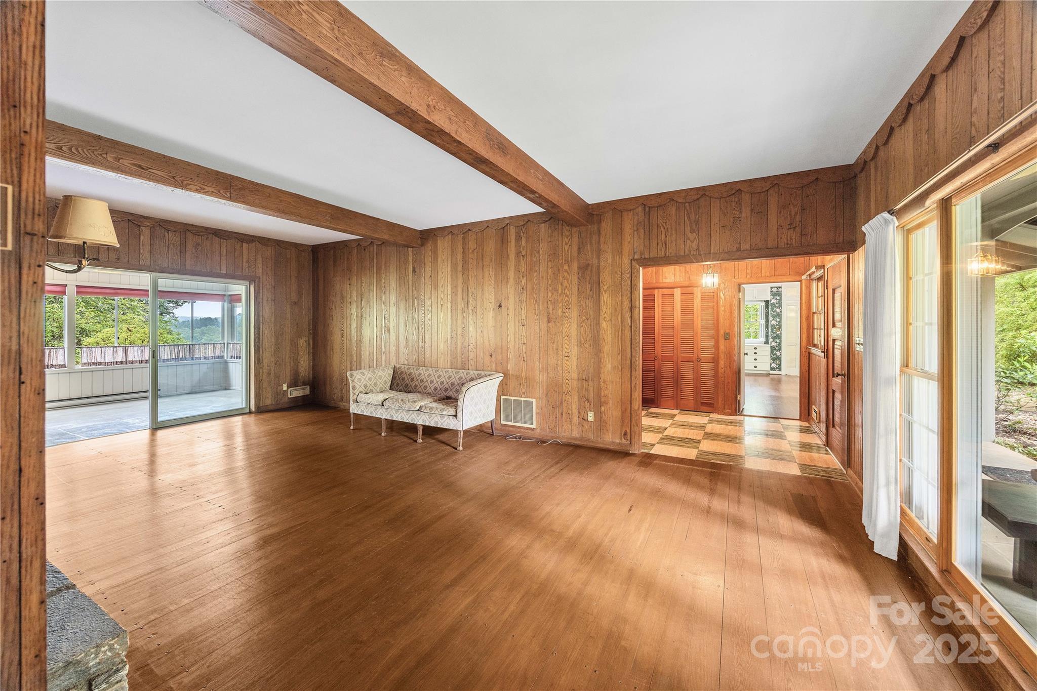 603 Green Hills Road Mill Spring, NC 28756 - Photo 9 of 47 a view of an empty room with glass door and furniture