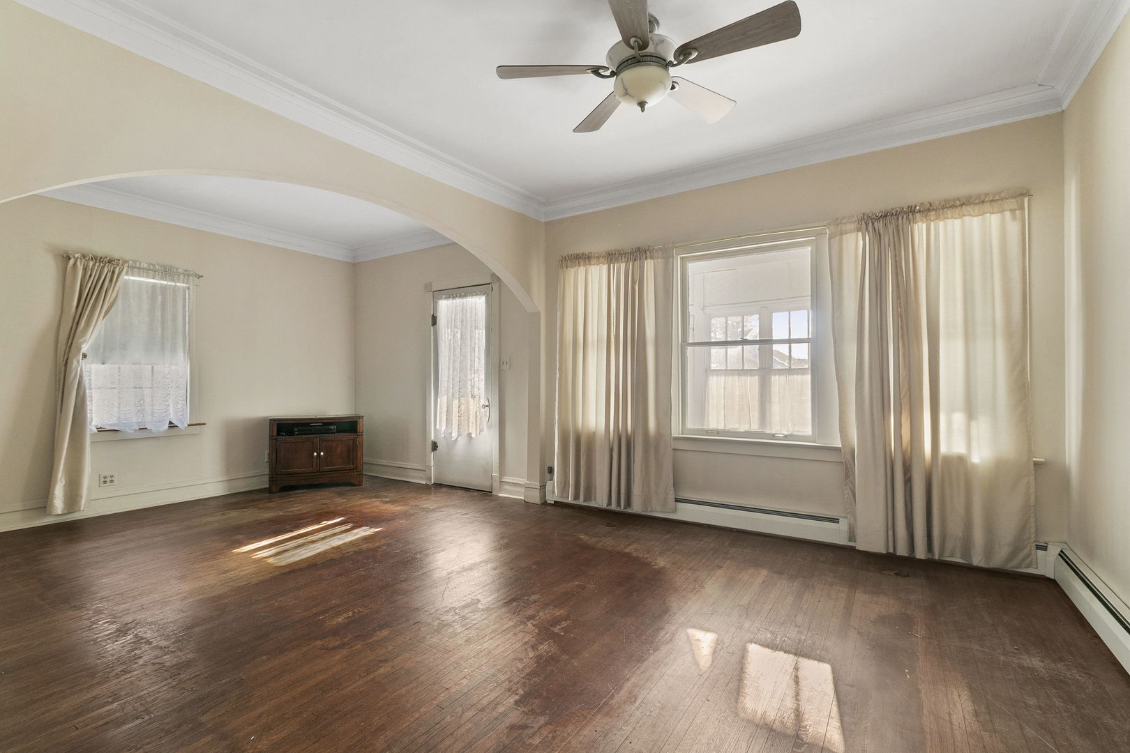 62 Northgate Road Riverside, IL 60546 - Photo 3 of 34 an empty room with wooden floor fan and windows