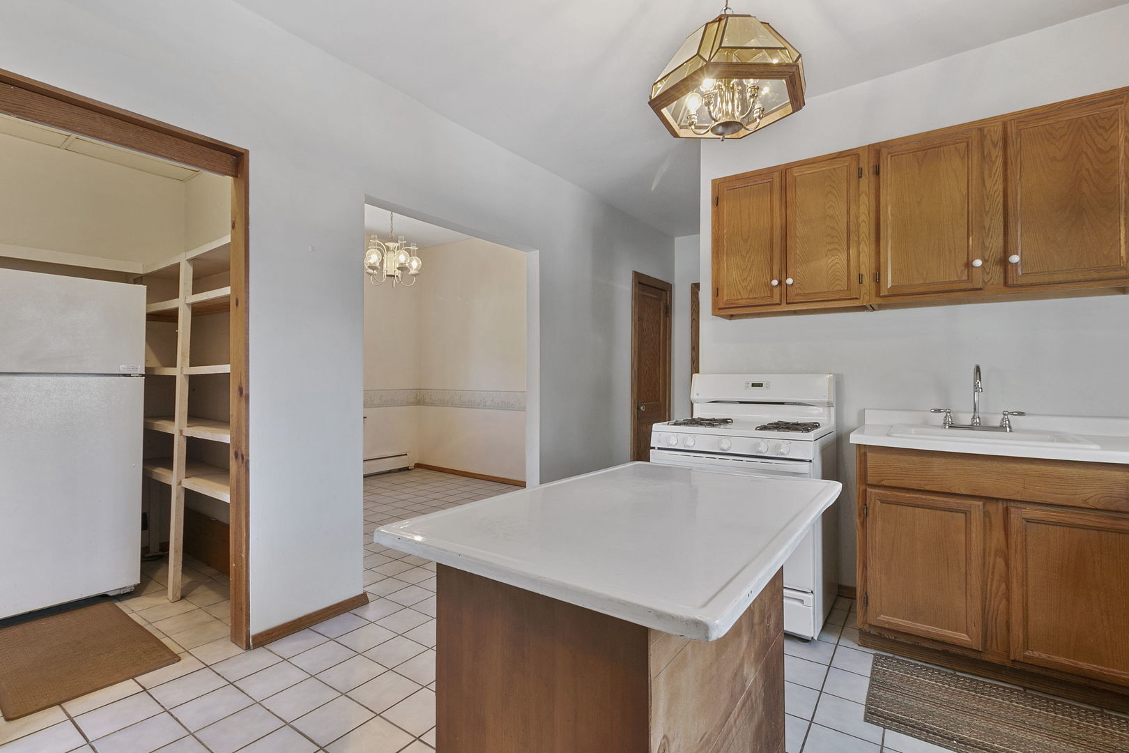 62 Northgate Road Riverside, IL 60546 - Photo 9 of 34 a kitchen with a stove a refrigerator and a sink